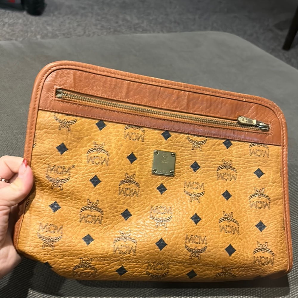 MCM tan  toiletry bag prelovwd w runninggs and signs of wear